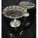 A matched pair of pierced silver bonbon dishes with flower head shaped baskets,