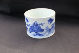 A Chinese Kang Xi period blue and white cylindrical brush pot with slightly waisted sides to the