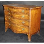 A George III serpentine fronted mahogany chest of four graduated drawers with brass embossed oval