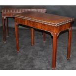 A pair of George III mahogany card tables in the manner of Thomas Chippendale,