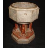 A travelling marble font, the bowl with faceted sides in a grey and pink veined marble,