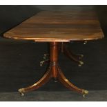 A George III style mahogany triple pillar dining table, circa 1900 with alterations,