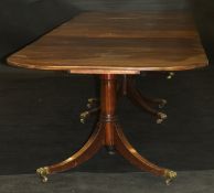 A George III style mahogany triple pillar dining table, circa 1900 with alterations,