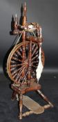 A 19th Century fruitwood and elm spinning wheel of typical form with turned and ringed spindle