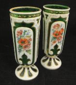 A pair of Victorian Bohemian overlaid green glass vases decorated with a fox and cat,