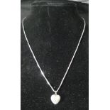 A diamond encrusted heart-shaped pendant on white metal mount with 9 carat white gold chain,