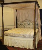 A George III style mahogany full tester bedstead with drapes, the end posts of reeded tapering form,