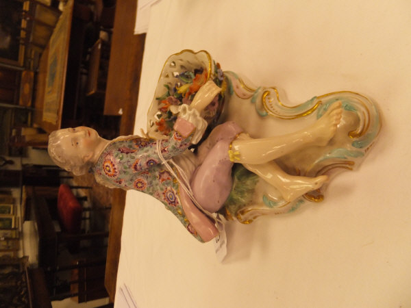 A pair of 19th Century Meissen figures as a recumbent gentleman and lady with baskets of flowers, - Image 3 of 48