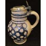 A 17th Century salt glazed Westerwald jug with pewter lid,
