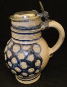 A 17th Century salt glazed Westerwald jug with pewter lid,