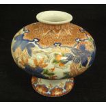 A Chinese Imari squat baluster shaped vase with all over floral spray and foliate decoration,