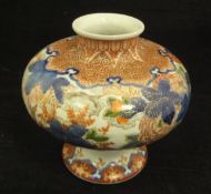 A Chinese Imari squat baluster shaped vase with all over floral spray and foliate decoration,