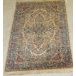 A Kirman rug, the central panel set with blue medallion within a floral decorated cream ground,