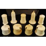 A collection of nine various early 20th Century turned and carved ivory cruet pieces including