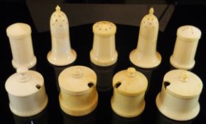 A collection of nine various early 20th Century turned and carved ivory cruet pieces including