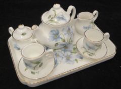 A china Classics tête-à-tête dolls' tea service comprising tray, teapot, milk jug,
