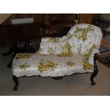 A Victorian chaise longue with button back and glazed floral upholstery,