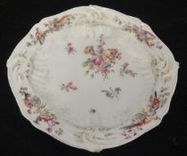 A Chelsea porcelain plate decorated with central floral sprays,