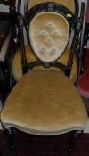 A Victorian ebonised and gilt decorated salon chair with spoon back and button seat and mustard