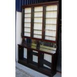 A Victorian mahogany apothecary cabinet with three large glazed doors enclosing adjustable shelving