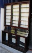 A Victorian mahogany apothecary cabinet with three large glazed doors enclosing adjustable shelving