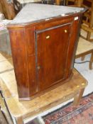 A 19th Century Oak wall hanging corner cupboard with single door opening to reveal fitted interior