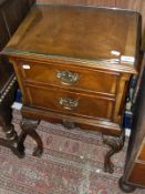 A walnut and cross banded miniature two drawer chest on carved cabriole legs to braganza feet