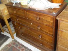 A circa 1900 mahogany chest of two short above three long drawers with turned handles to plinth