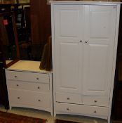 A two door wardrobe raised upon two short and one long drawer and a matching bedroom chest with