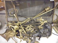 A set of brass fireside tools, firedogs, door porter, folding brass fire screen,