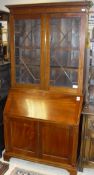 A 19th Century and later bureau bookcase with dentil cornicing above two astragal glazed doors