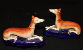 A pair of 19th Century Staffordshire greyhound inkwells