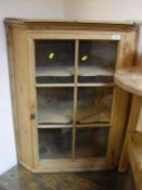 A Pine cricket table of typical form together with a pine corner cupboard,
