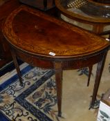 A 19th Century mahogany fold-over card table of demi-lune form,