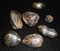 A collection of seven various filled silver nuts,