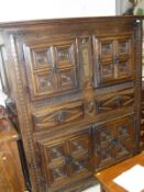 A 17th Century carved walnut cupboard with two panelled cupboard doors above two lozenge carved