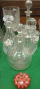 Three decanters, one stoppered jug, a paperweight,