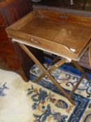 A late Victorian mahogany butlers tray on folding stand