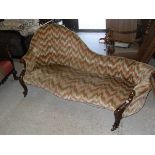 A Victorian walnut and carved framed chaise longue with spoon back,