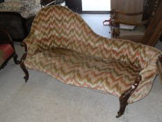 A Victorian walnut and carved framed chaise longue with spoon back,