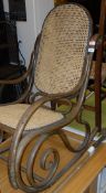 An early 20th Century bentwood rocking chair in the manner of Thonet with cane seat and back,
