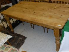 A rectangular pine plank top kitchen table on turned legs