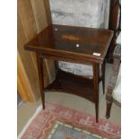 An Edwardian mahogany and satinwood cross banded and inlaid tea table with foldover spinning top,
