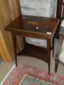 An Edwardian mahogany and satinwood cross banded and inlaid tea table with foldover spinning top,