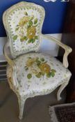 A pair of Louis XVI style open arm chairs with painted frames and floral upholstery