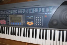 A Casio WK-1200 electric keyboard on stand