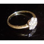 A 9 carat gold ladies dress ring set with seven small diamonds in flowerhead form