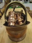 A collection of brass copper wares to include graduated copper mugs,