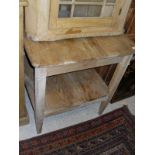 A late Victorian pine two tier kitchen table on square supports