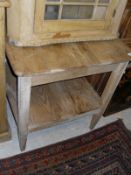 A late Victorian pine two tier kitchen table on square supports